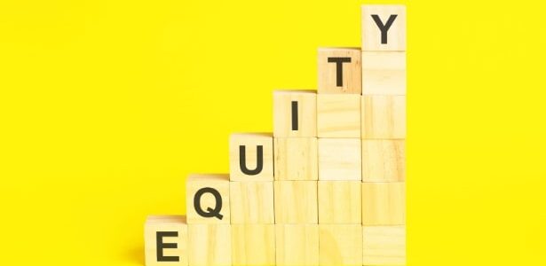 Wooden blocks stacked to form a staircase, with the word "EQUITY" spelled vertically using black letters on the blocks, against a bright yellow background.