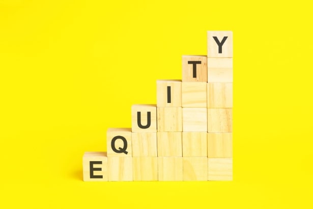 Wooden blocks stacked to form a staircase, with the word "EQUITY" spelled vertically using black letters on the blocks, against a bright yellow background.