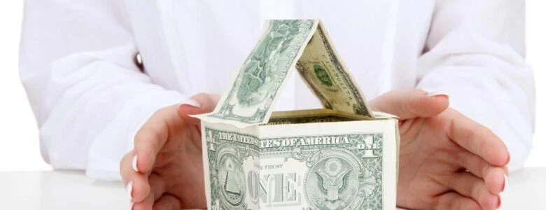 Hard money loan financing concept showing a California house model next to stacks of cash, representing ARC Private Lending real estate funding.
